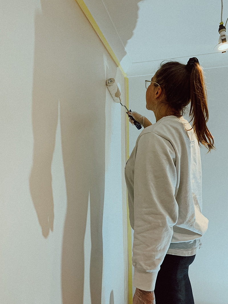 Pip painting a white wall